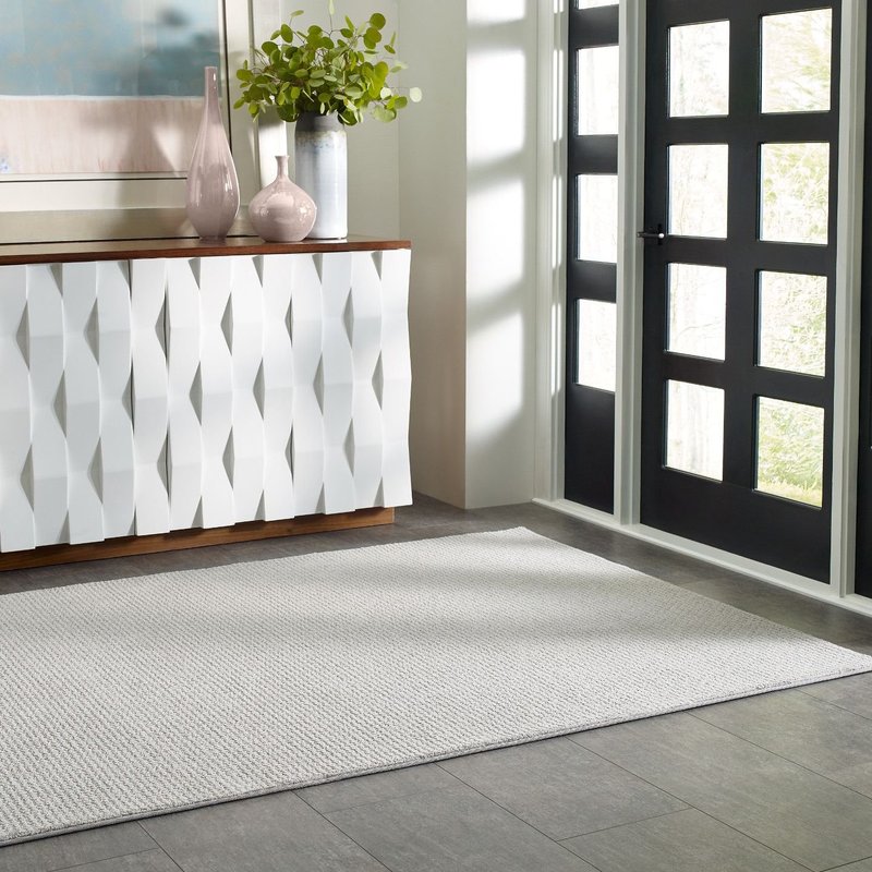 white cabinet on entrance area and a white rug in front of a black door - Shamrock Carpets in Uniontown, PA