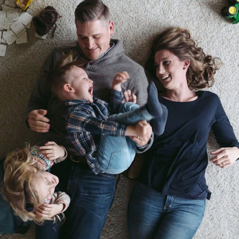 Wells Fargo Financing Logo: Family laying on carpet