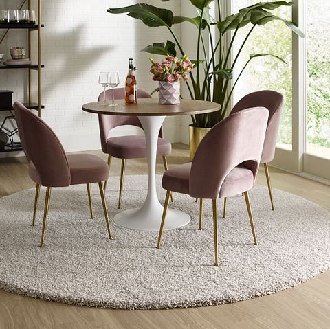 small round table with four chairs on a round area rug - Shamrock Carpets in Uniontown, PA