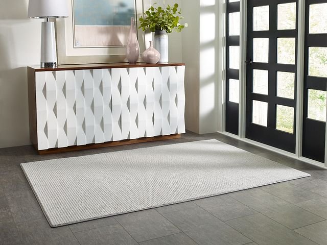 entry way with white textured cabinet and area rug in front of door - Shamrock Carpets in Uniontown, PA